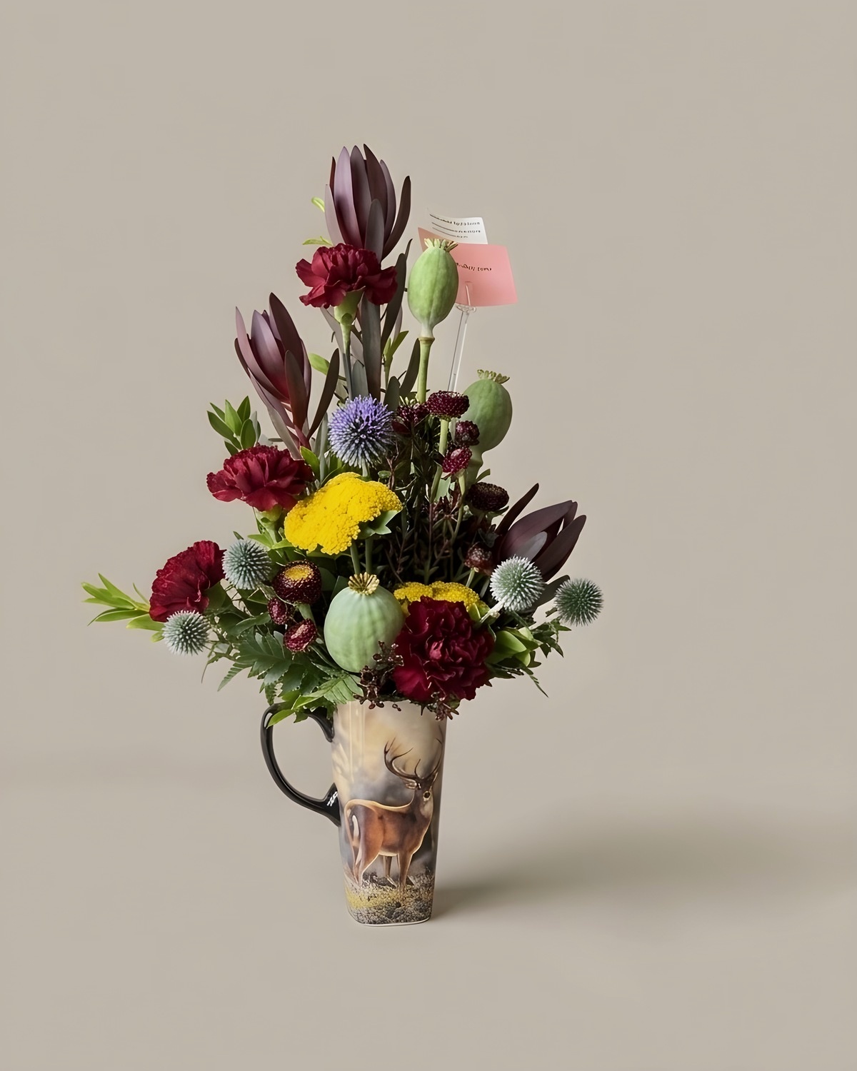 Tall arrangement with poppy pods, thistle and protea