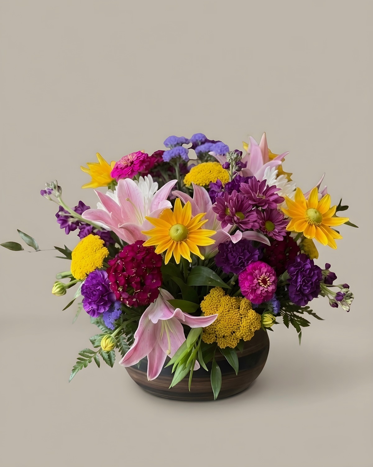 Purple, yellow and pink mixed arrangement in a glass vase