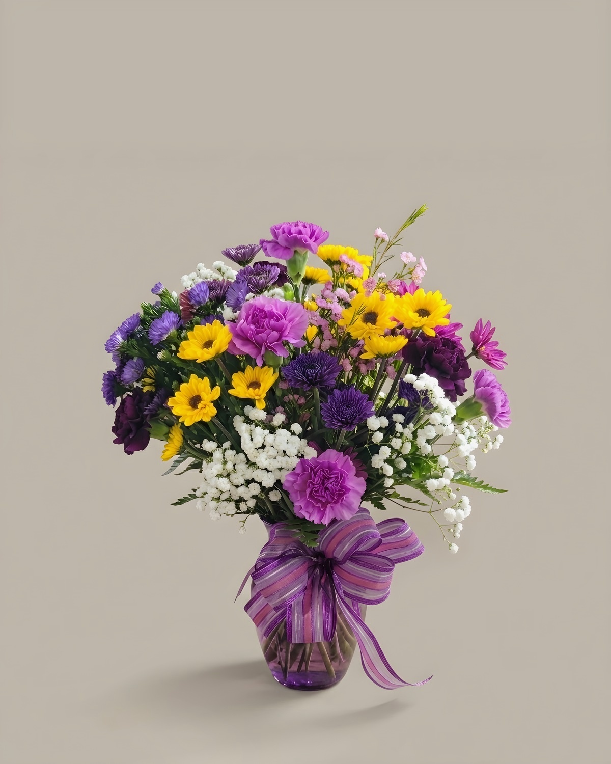 Purple and yellow daisy bouquet with baby's breath and a purple ribbon
