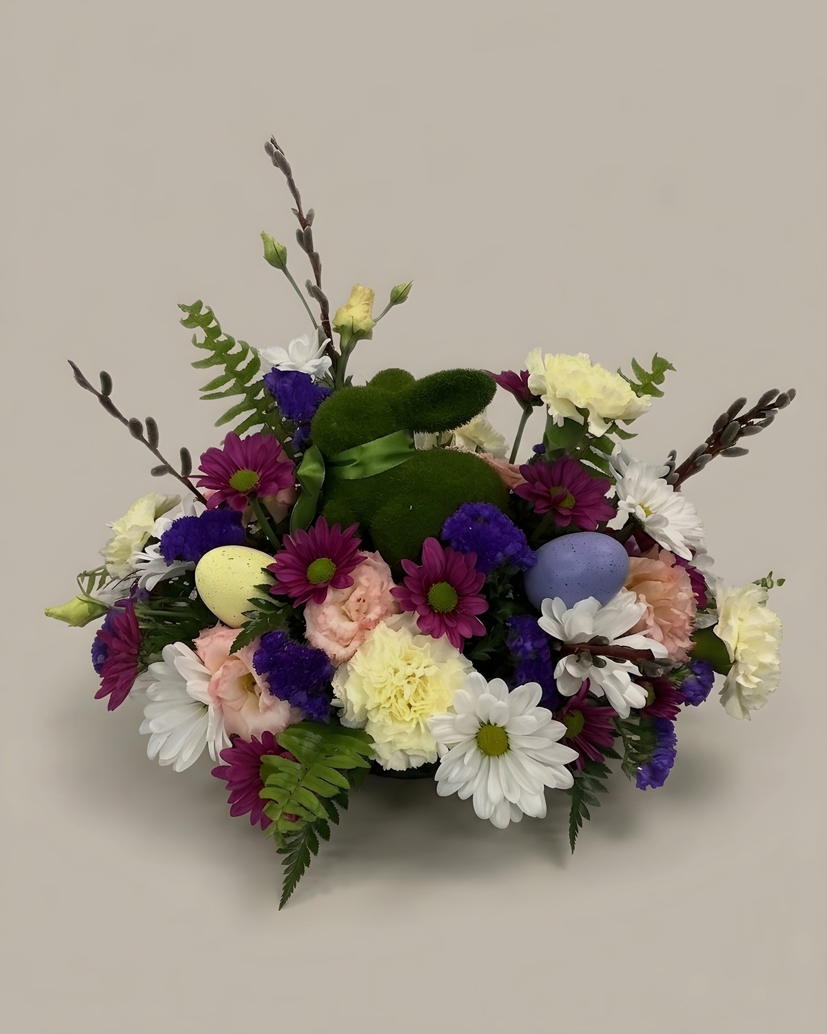 Pastel daisies, cream carnations, pussy willow and decorated eggs